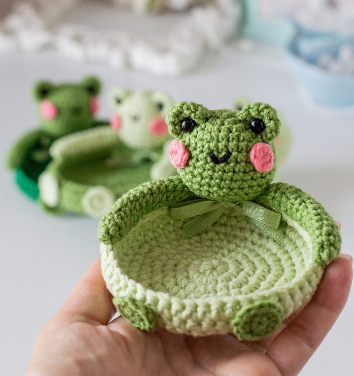 Hands finishing a crochet piece in the Wow Threads studio